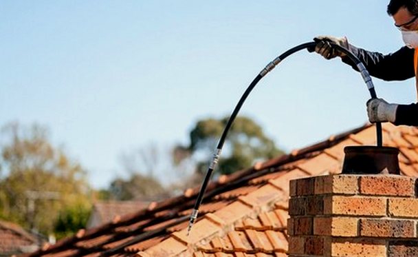 Sweeping rods paid out down the chimney flue