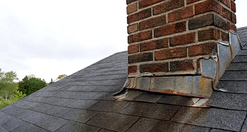 Rust washing down a roof from a failing chimney flashing